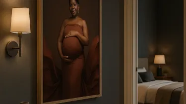 Large framed maternity portrait hanging in a hallway, showing how professional photography becomes artwork in the home.